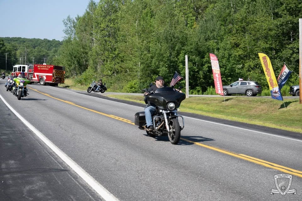 Motorcycle parade with Monmouth Fire Department escort rolling through the 2026 route.