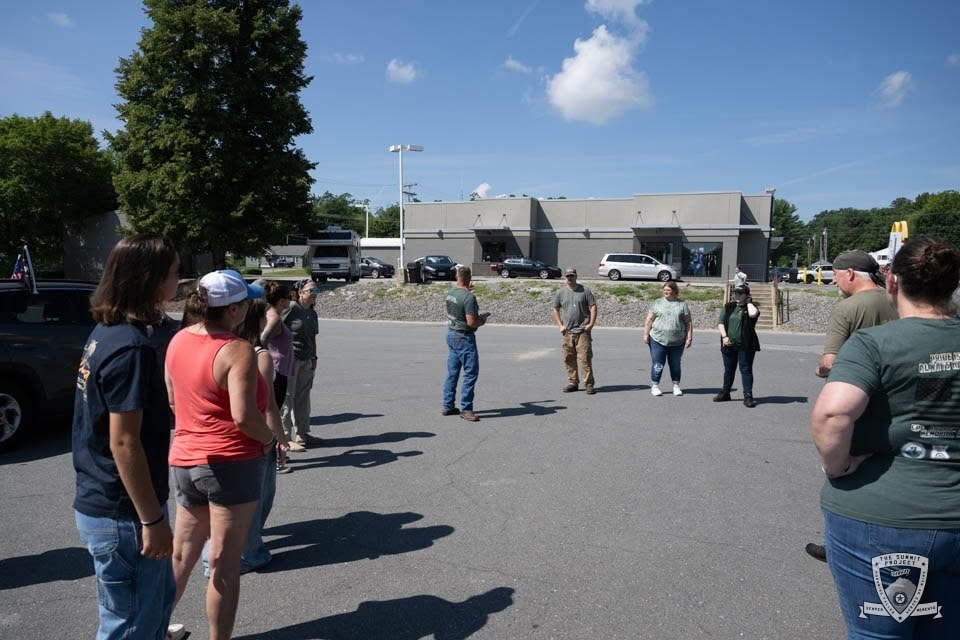 Riders and supporters gather for a briefing at the midpoint stop along the route.