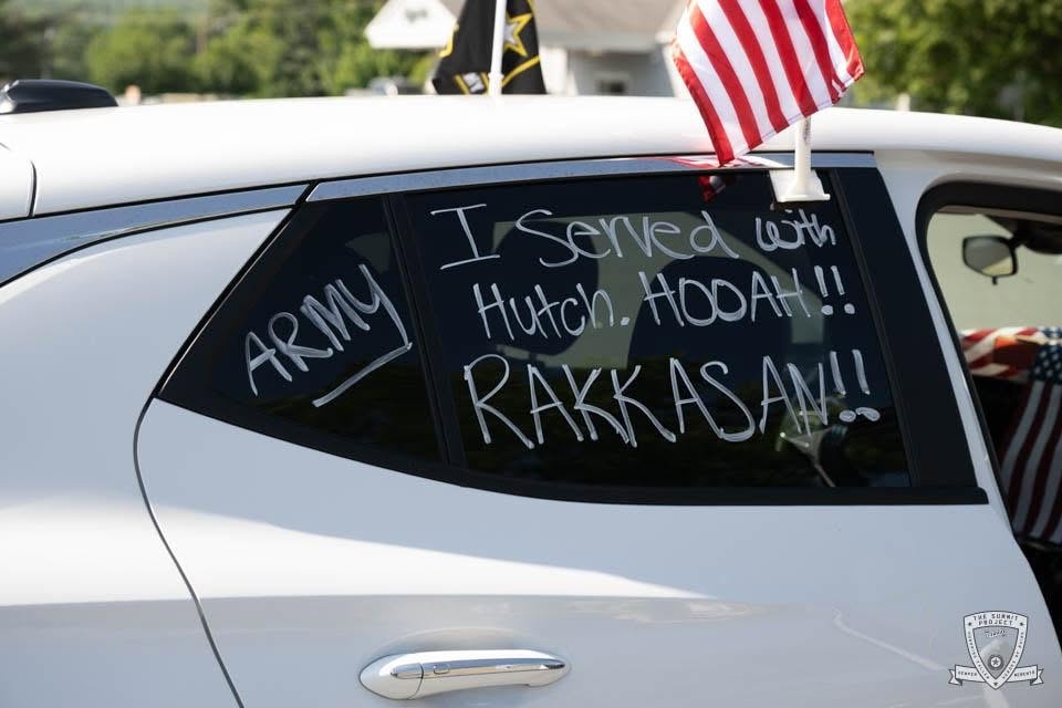 A white Buick in the procession bears a heartfelt tribute: "Forever Remember My Brother — Nov 8, 2010."