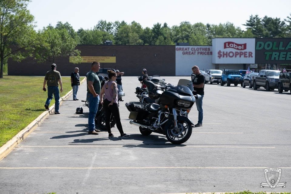 Riders gather in the Jay Plaza parking lot at the midpoint fuel stop.
