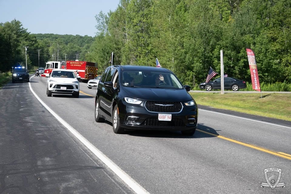 The procession stretches down the road — vehicles of all kinds honoring Andrew's memory.